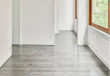 Empty-hallway-with-gray-flooring-renovated-by-a-handyman