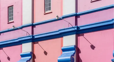 Pink-and-blue-painted-building-facade-with-ornate-details