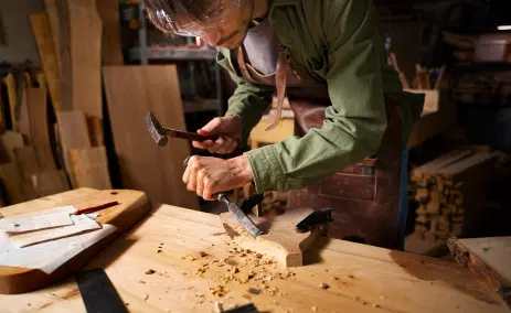 carpenter-hand-carving-wood-in-a-workshop