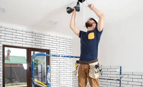worker-installing-a-light-fixture-on-a-ceiling